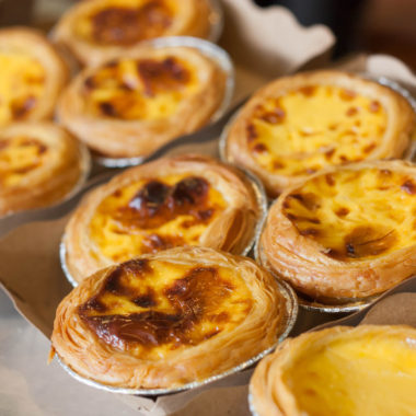 Egg tart or portuguese egg tart on recycled paper.