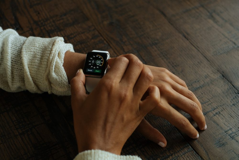 Person setting the time on his watch to arrive to his Japanese job interview on time