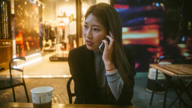 woman talking on the phone in a modern café