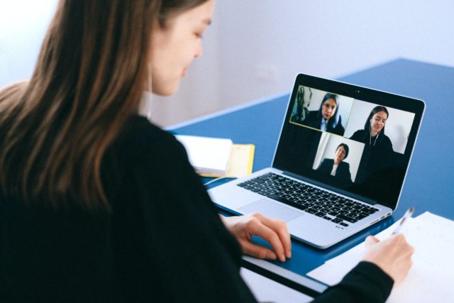 woman in a professional outfit having a virtual interview