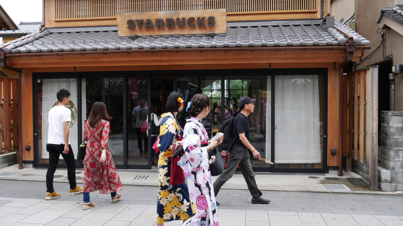 Kimono girls walk past a Japanese Starbucks in Kawagoe