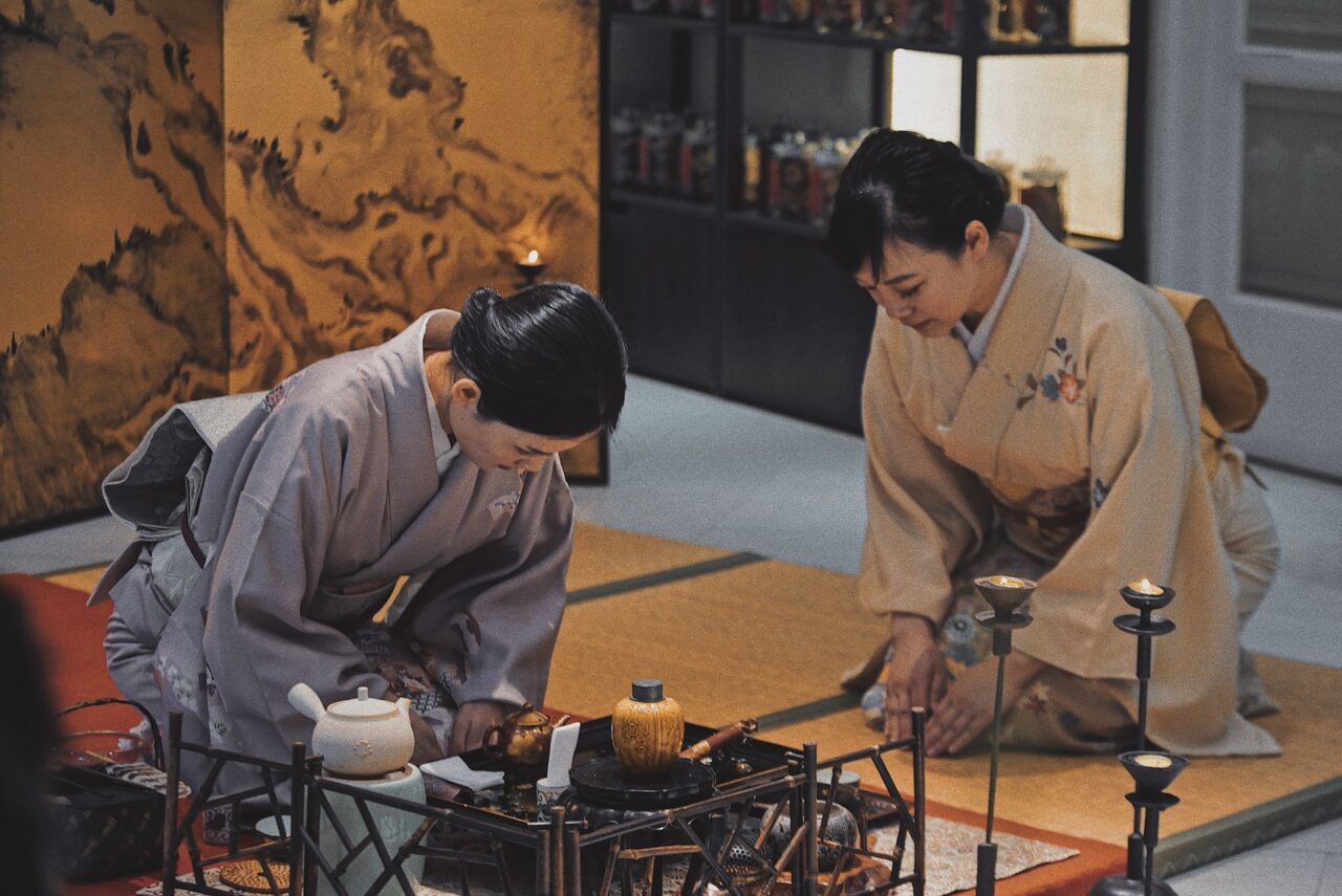 Two Japanese Women demonstrating Omotenshi and hospitality during a traditional tea ceremony in Japan.